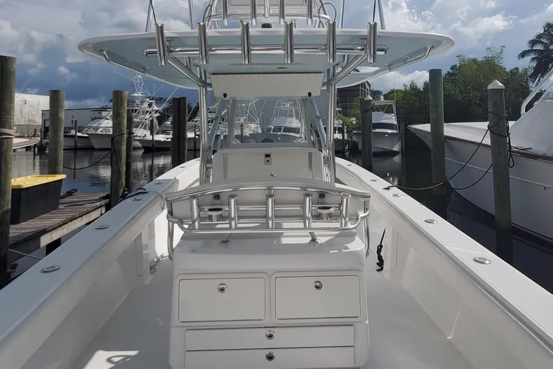 Dragonfly Yacht Photos Pics 2014 Bahama 41 FS boat docked, featuring spacious deck and fishing rod holders.