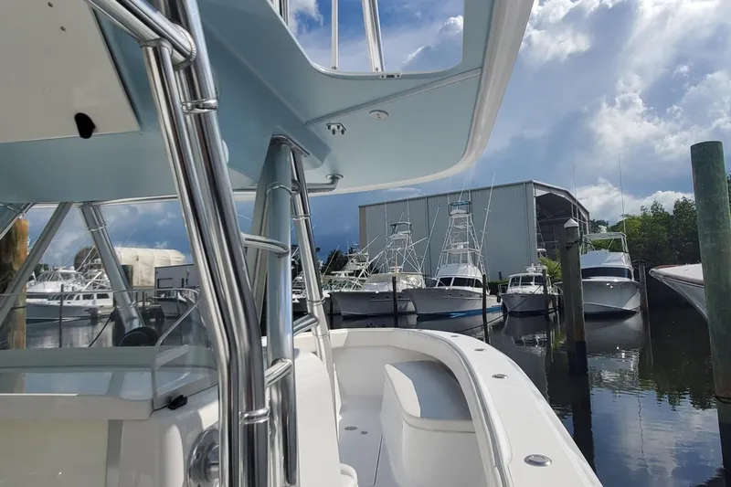 Dragonfly Yacht Photos Pics 2014 Bahama 41 FS boat docked at marina under cloudy sky.