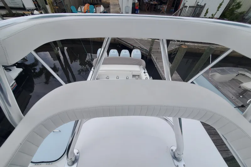 Dragonfly Yacht Photos Pics 2014 Bahama 41 FS boat with white seating and triple outboard engines.