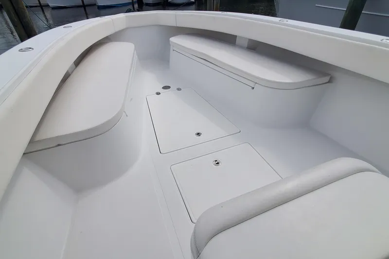 Dragonfly Yacht Photos Pics 2014 Bahama 41 FS boat interior with white seating and storage compartments.