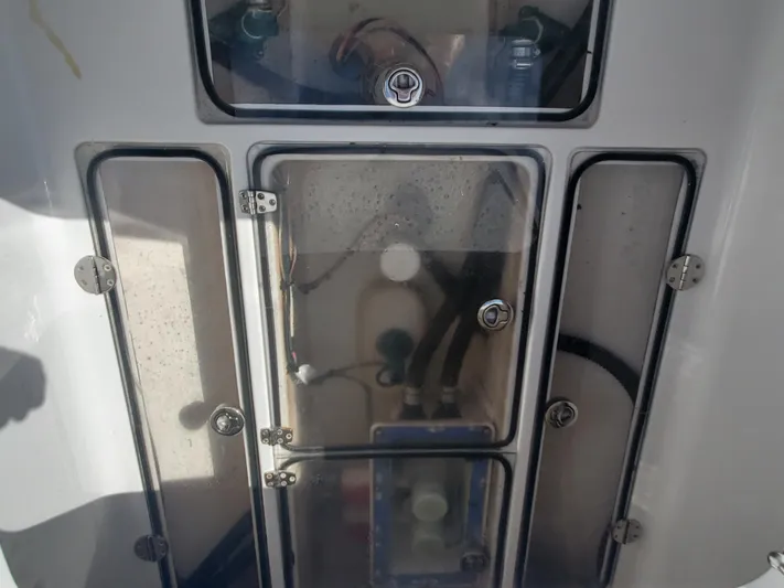 Dragonfly Yacht Photos Pics 2014 Bahama 41 FS boat compartment with transparent covers and visible wiring.