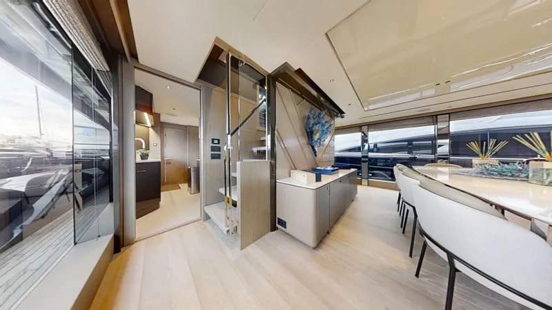 Majic Yacht Photos Pics Luxurious interior of 2023 Sunseeker 100 Yacht with modern dining area and staircase.