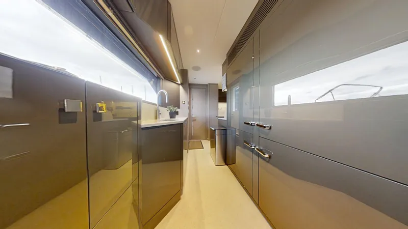 Majic Yacht Photos Pics Luxurious modern kitchen interior on 2023 Sunseeker 100 Yacht, featuring sleek cabinetry and fixtures.