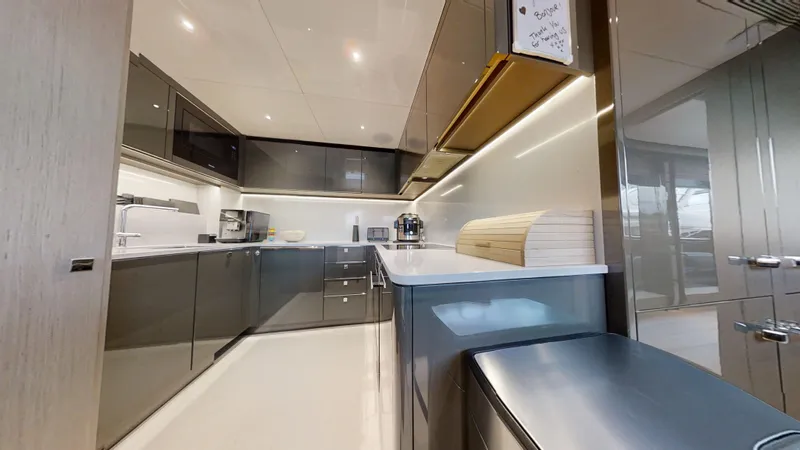 Majic Yacht Photos Pics Modern kitchen interior on 2023 Sunseeker 100 Yacht, featuring sleek cabinetry and appliances.