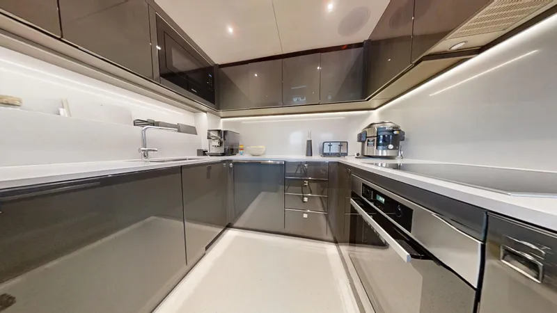 Majic Yacht Photos Pics Modern kitchen interior on 2023 Sunseeker 100 Yacht, featuring sleek cabinetry and appliances.