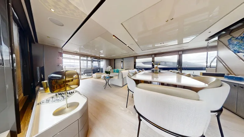 Majic Yacht Photos Pics Luxurious interior of 2023 Sunseeker 100 Yacht with elegant dining area and panoramic windows.