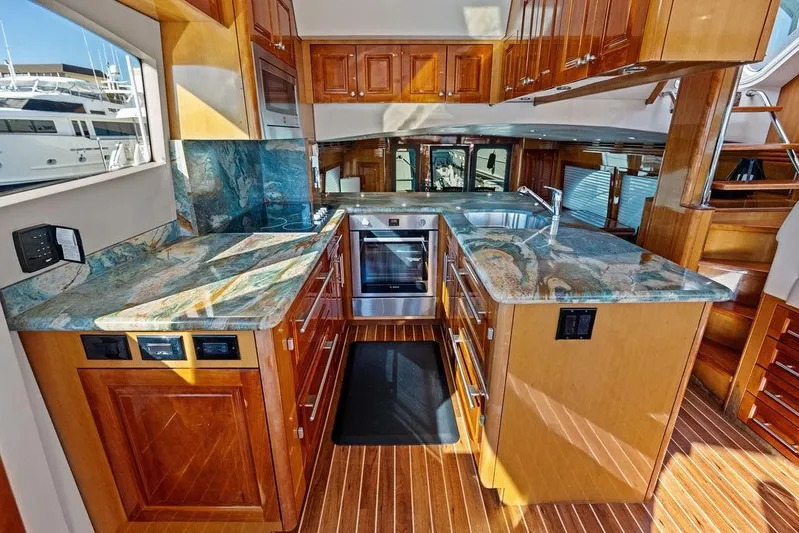 Satellite Office Yacht Photos Pics Luxurious kitchen interior of 2008 Hatteras 64 Motor Yacht with marble countertops.