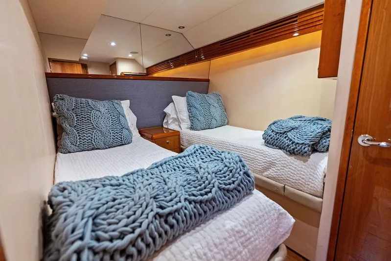 Satellite Office Yacht Photos Pics Cozy twin cabin in 2008 Hatteras 64 Motor Yacht with knitted blankets and pillows.