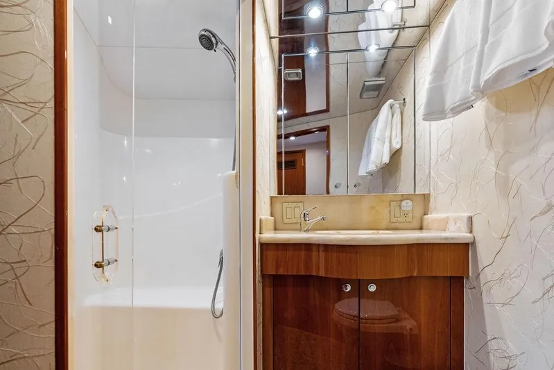 Satellite Office Yacht Photos Pics Luxurious bathroom in 2008 Hatteras 64 Motor Yacht with modern shower and vanity.