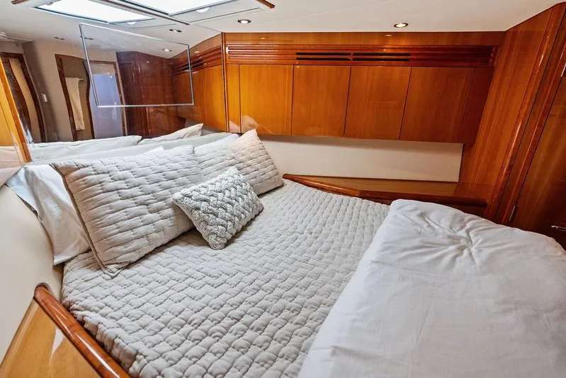 Satellite Office Yacht Photos Pics Luxurious bedroom interior of 2008 Hatteras 64 Motor Yacht with elegant wood finishes.