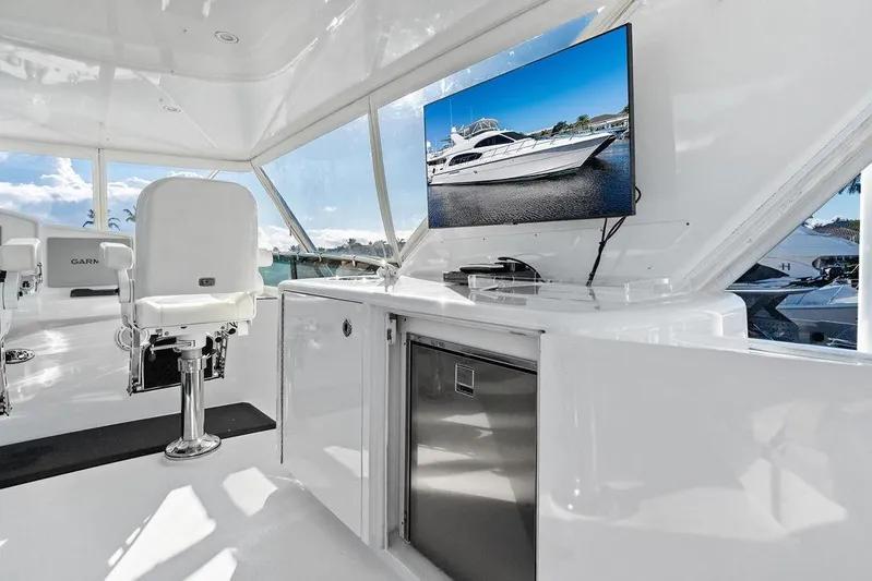 Satellite Office Yacht Photos Pics Luxurious interior of 2008 Hatteras 64 Motor Yacht with modern seating and TV display.