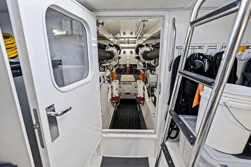 Satellite Office Yacht Photos Pics Engine room of 2008 Hatteras 64 Motor Yacht with visible equipment and ladder.