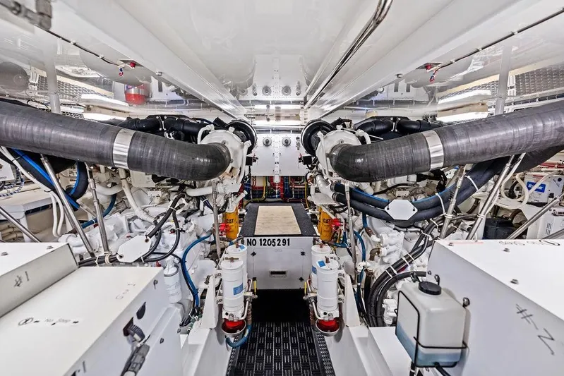 Satellite Office Yacht Photos Pics Engine room of 2008 Hatteras 64 Motor Yacht, showcasing complex machinery and piping.