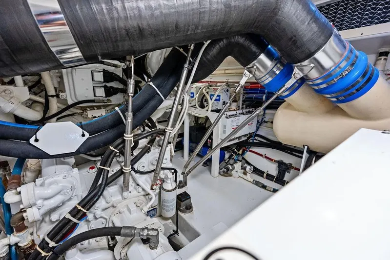 Satellite Office Yacht Photos Pics Engine room of 2008 Hatteras 64 Motor Yacht, showcasing complex piping and machinery.