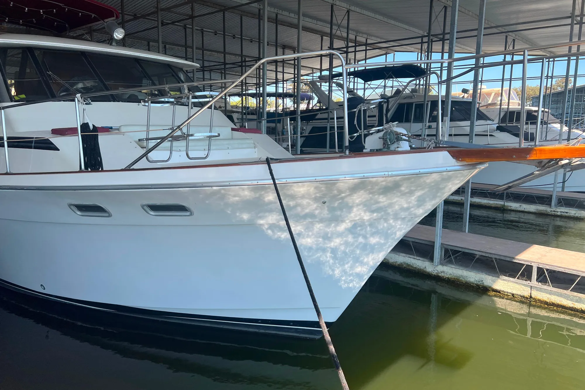 1986 Bayliner 4550 Motoryacht docked in a marina, side view.