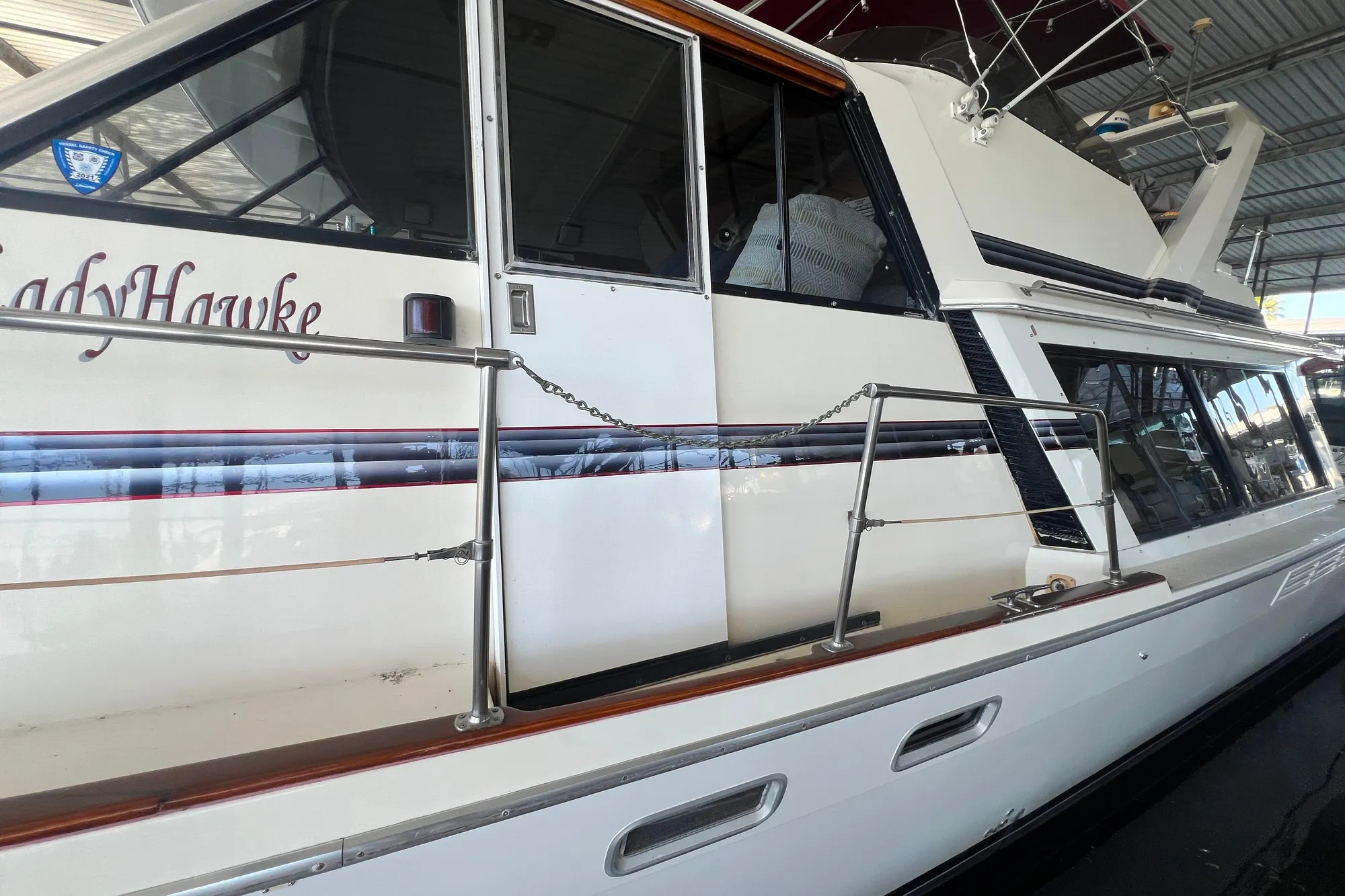 1986 Bayliner 4550 Motoryacht docked in a covered marina.