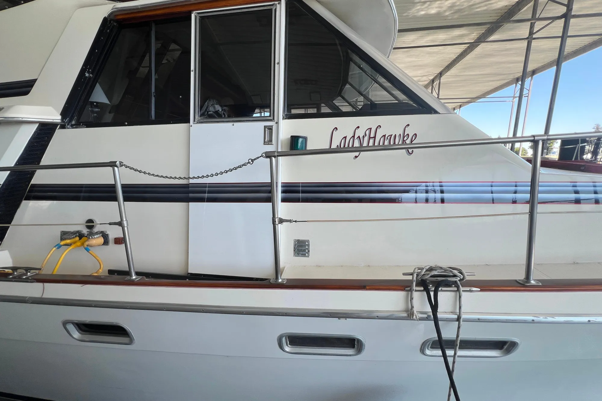 1986 Bayliner 4550 Motoryacht "LadyHawke" docked under a canopy.