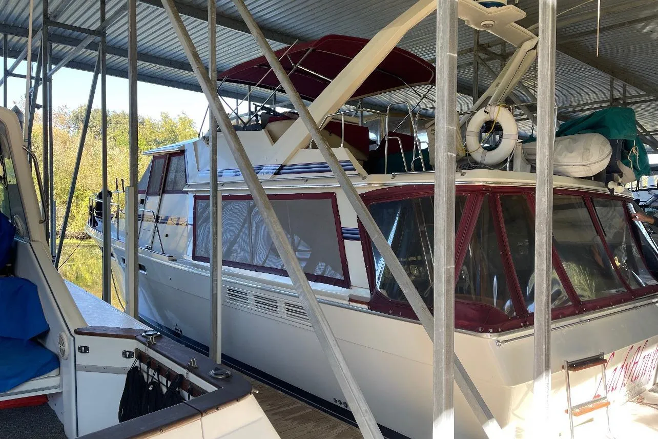 1986 Bayliner 4550 Motoryacht docked under a metal canopy.