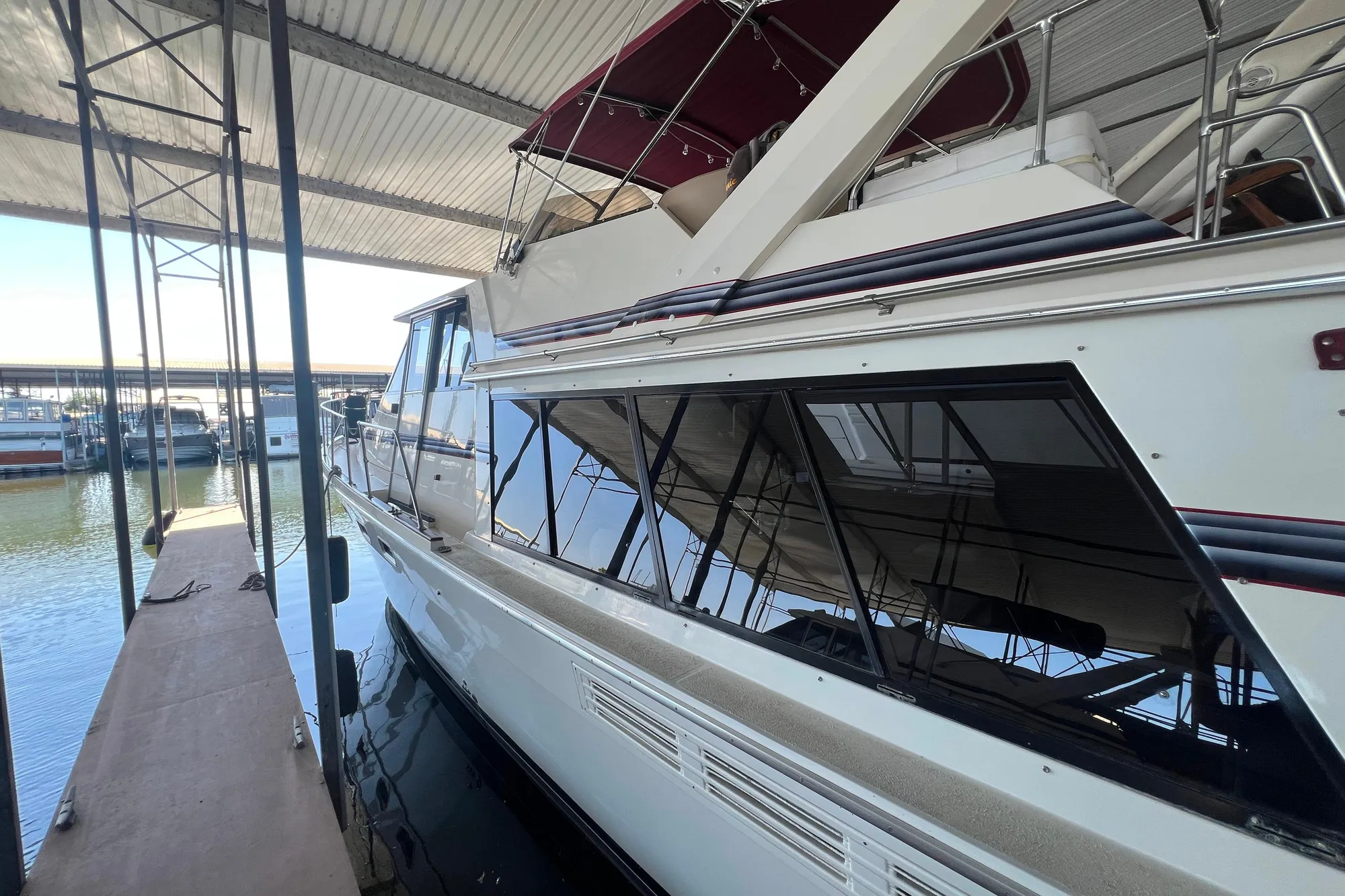 1986 Bayliner 4550 Motoryacht docked under a covered marina.