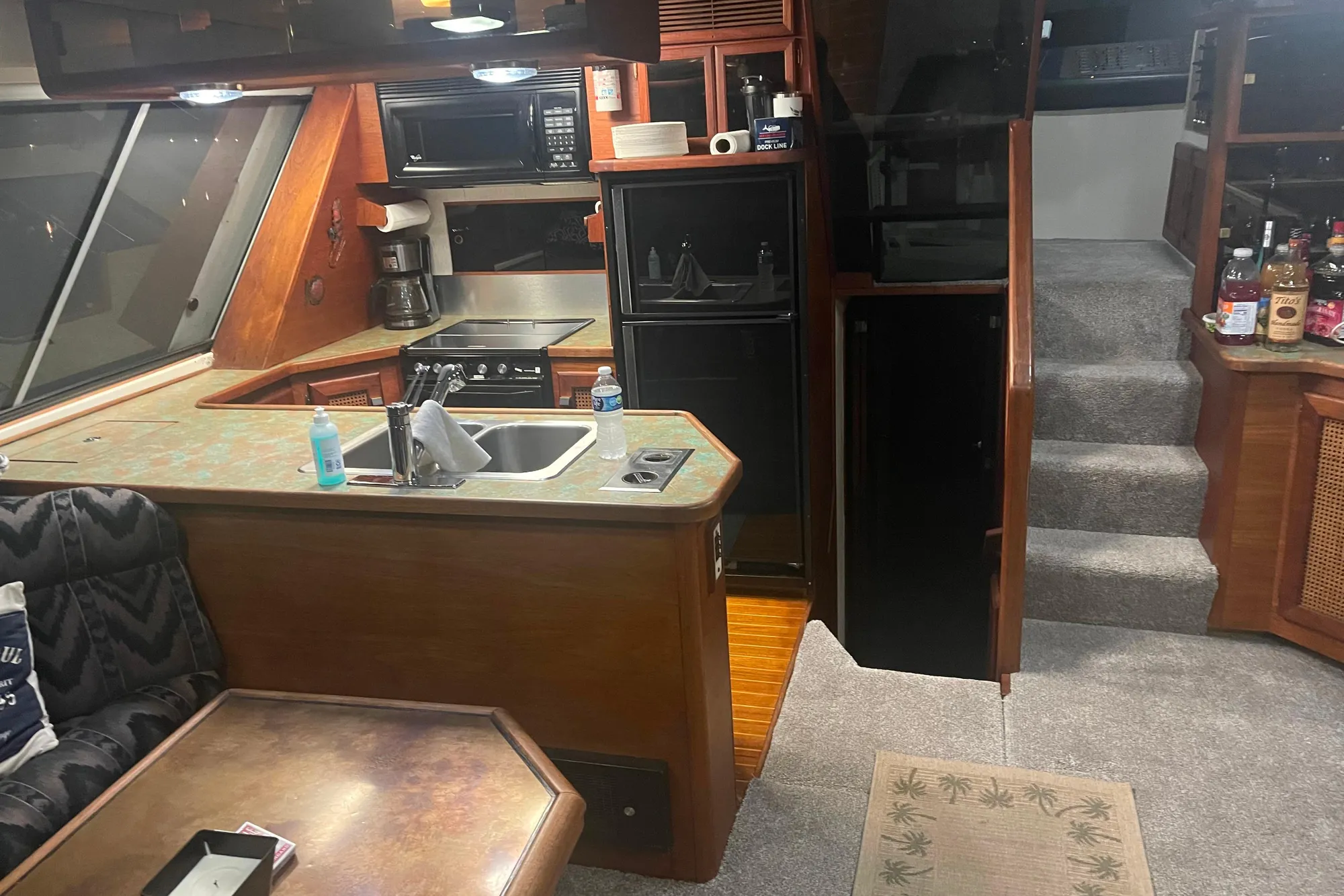 Interior of 1986 Bayliner 4550 Motoryacht with kitchen, stairs, and seating area.
