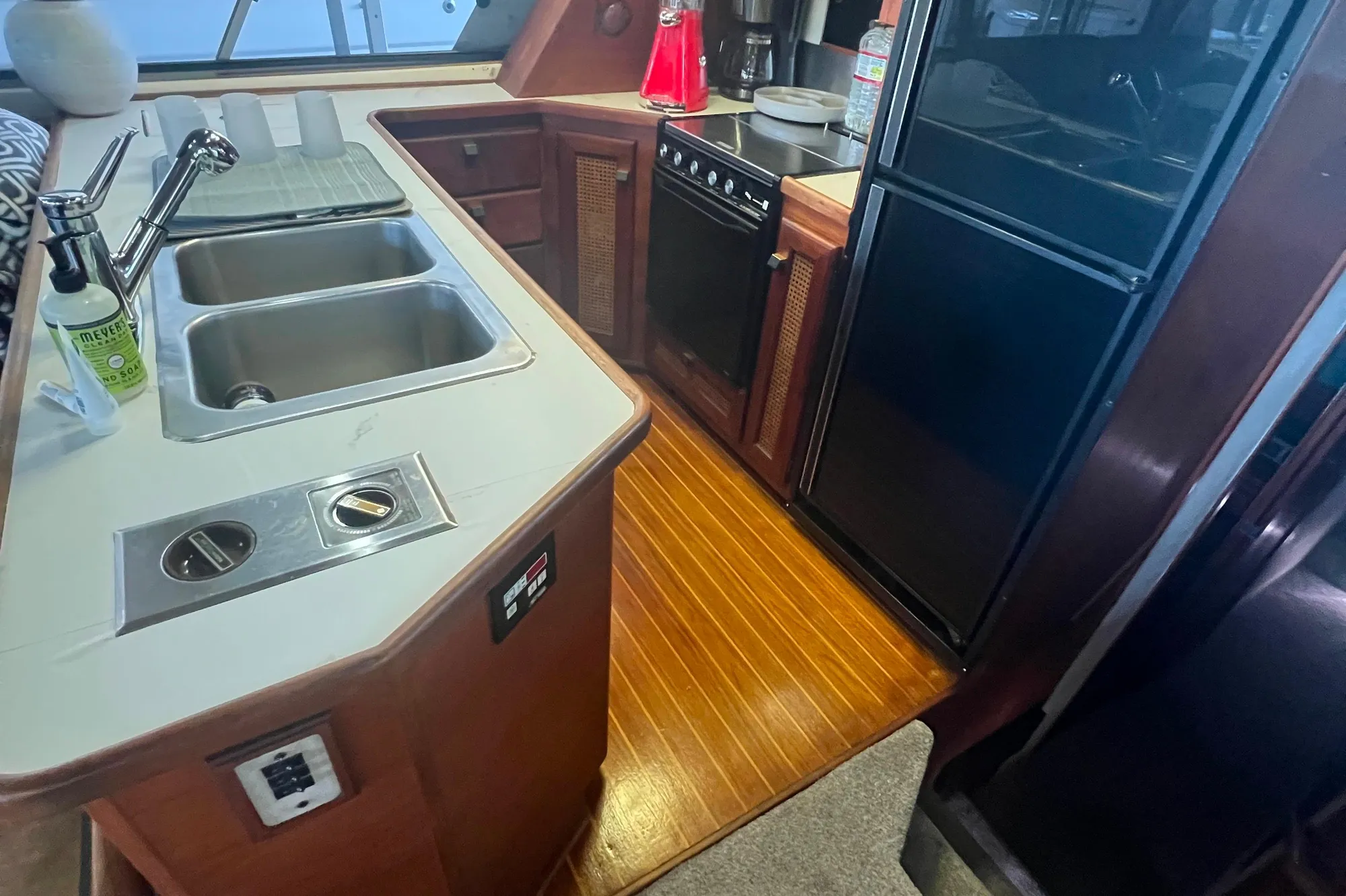 1986 Bayliner 4550 Motoryacht kitchen with dual sinks, stove, and refrigerator.
