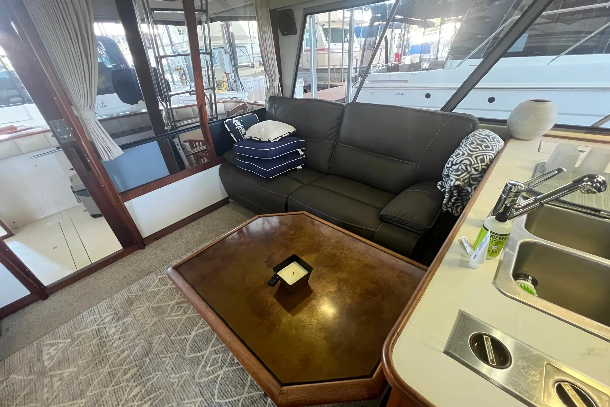 Interior of 1986 Bayliner 4550 Motoryacht with sofa, table, and kitchenette.