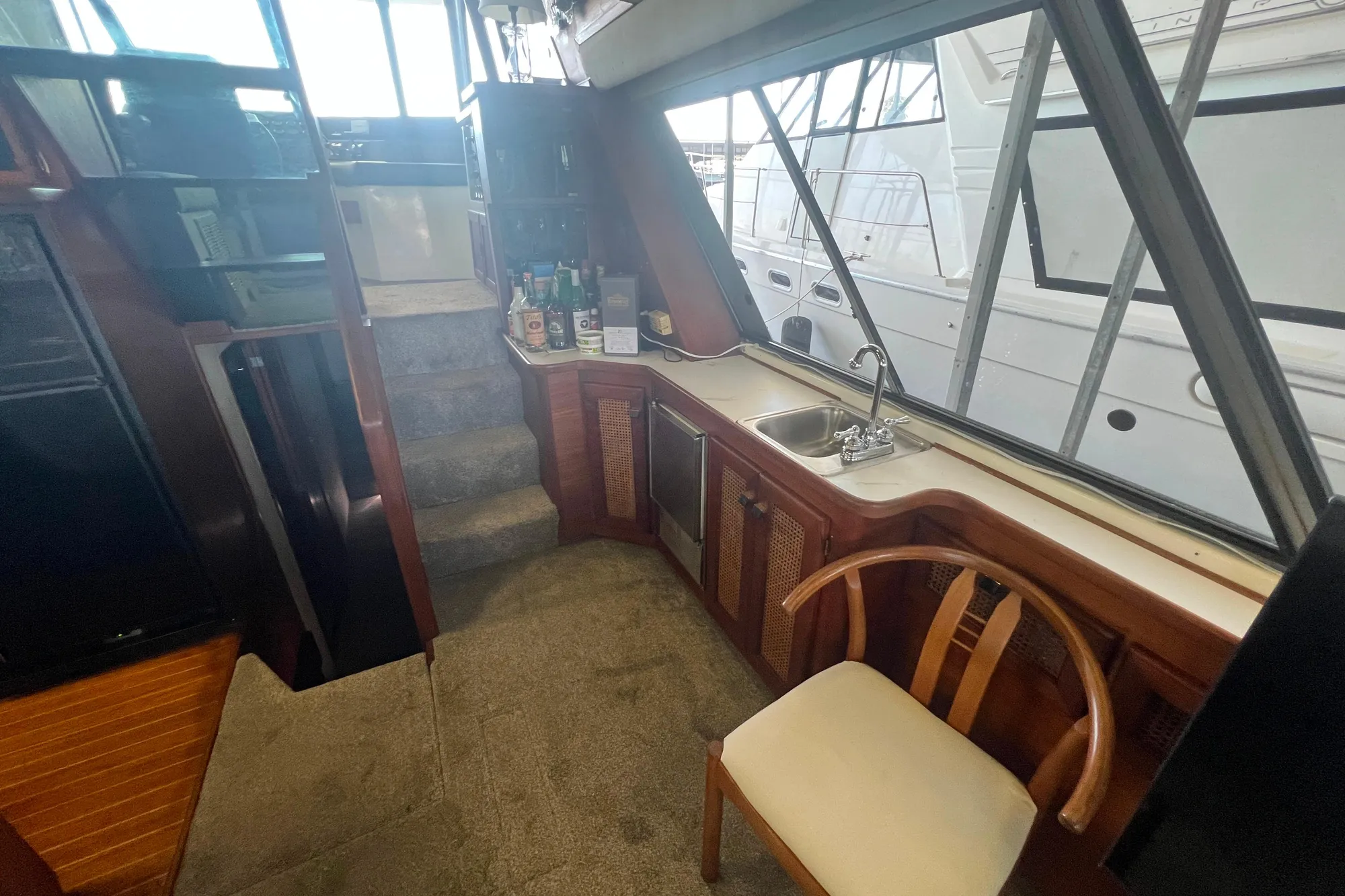 Interior of 1986 Bayliner 4550 Motoryacht with kitchenette and seating area.