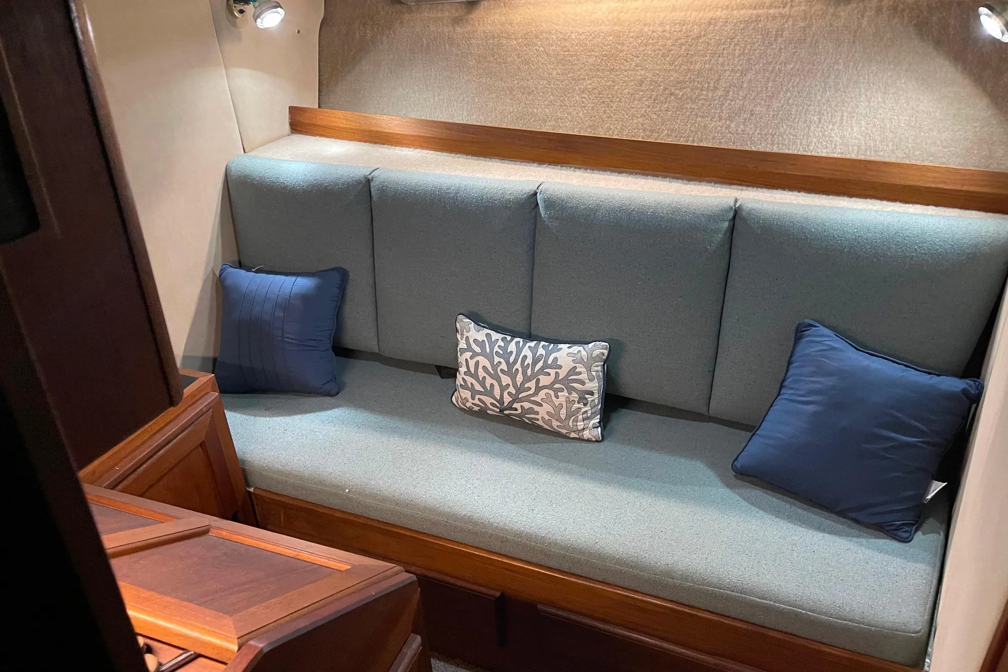1986 Bayliner 4550 Motoryacht interior with cushioned seating and decorative pillows.