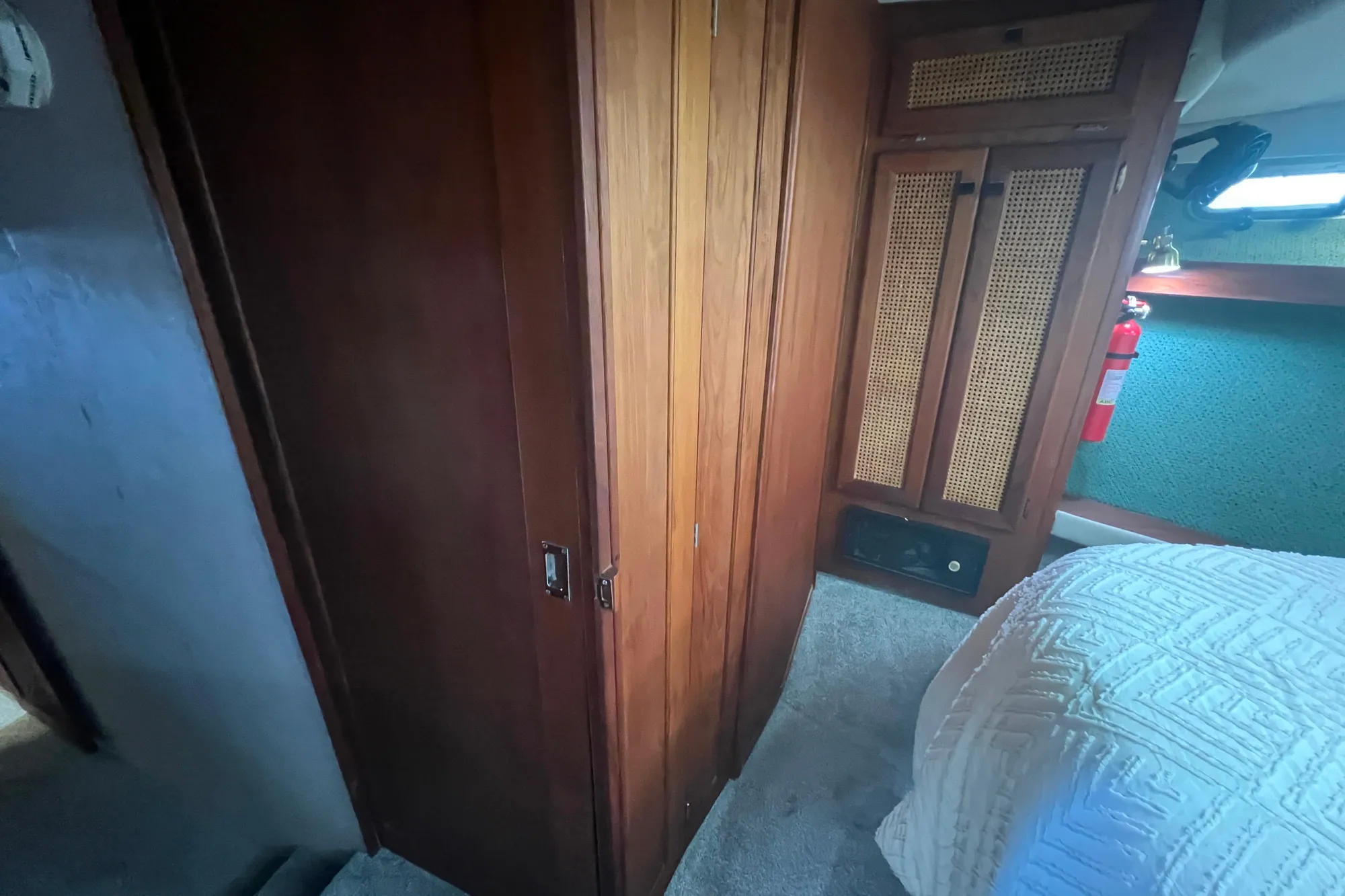 Interior of 1986 Bayliner 4550 Motoryacht with wood paneling and cozy bedroom.