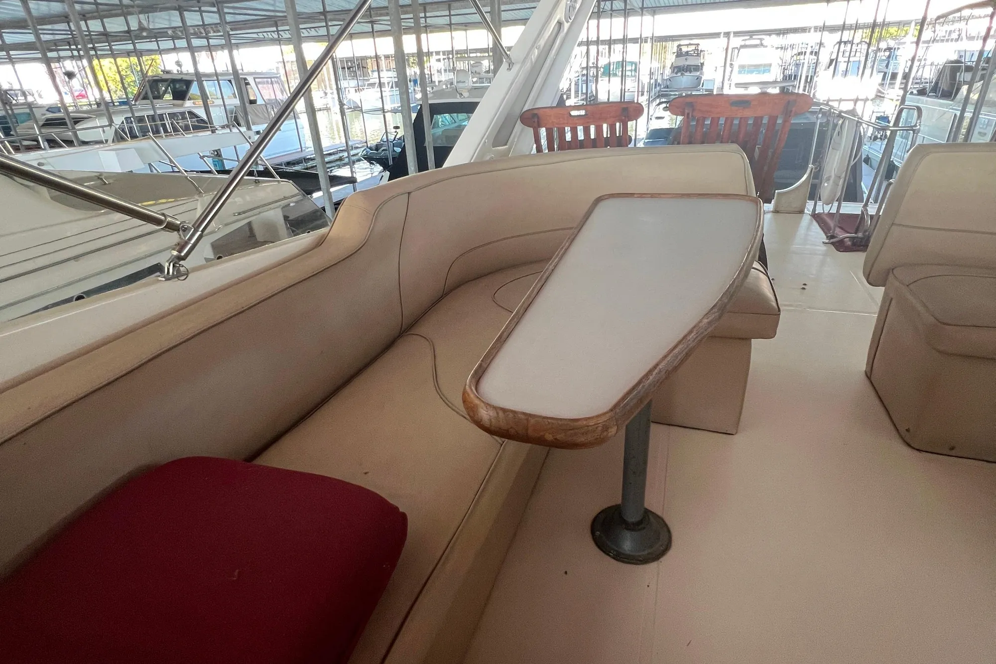 1986 Bayliner 4550 Motoryacht interior with beige seating and wooden table.
