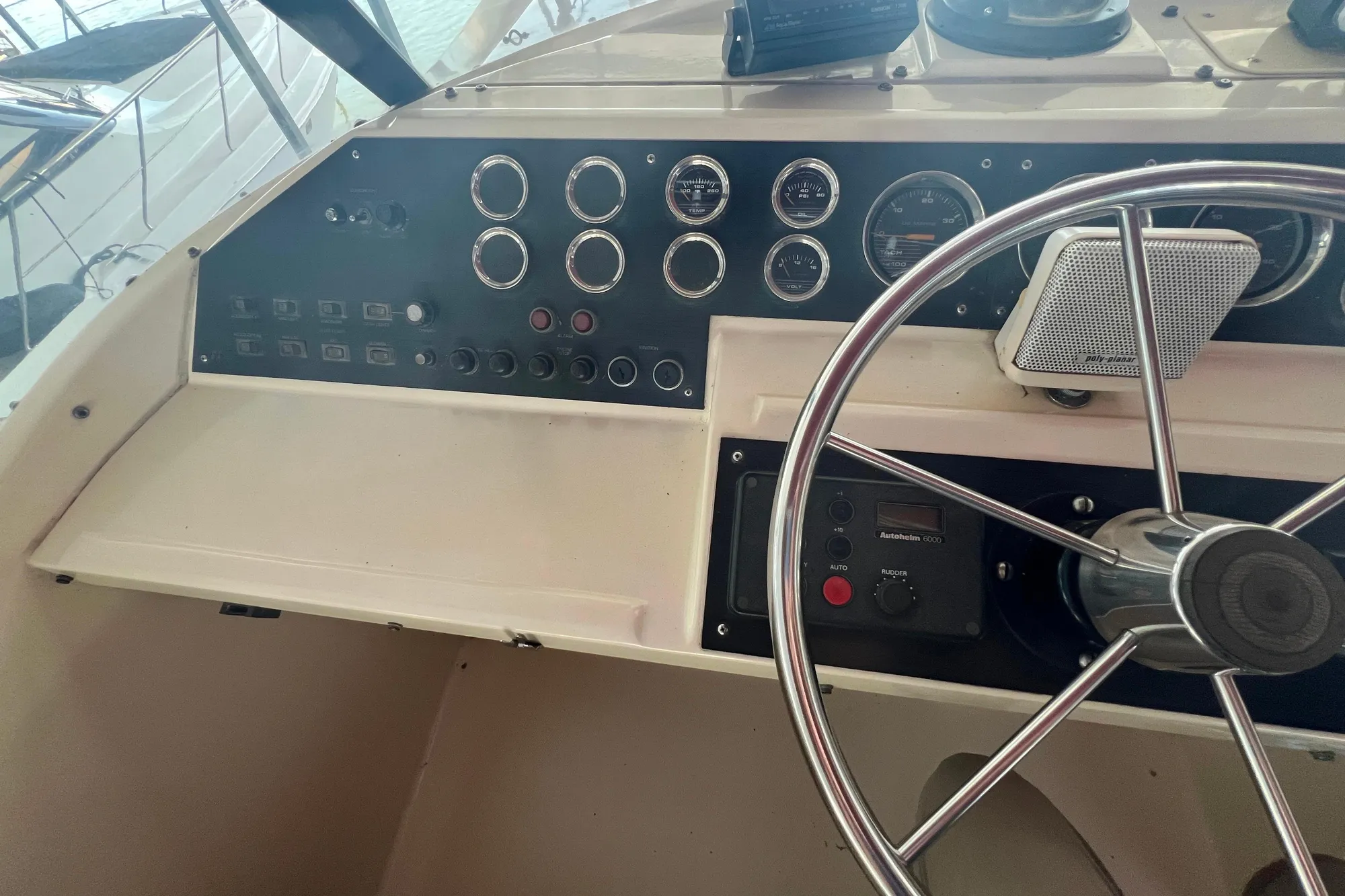 Control panel of 1986 Bayliner 4550 Motoryacht with steering wheel and gauges.