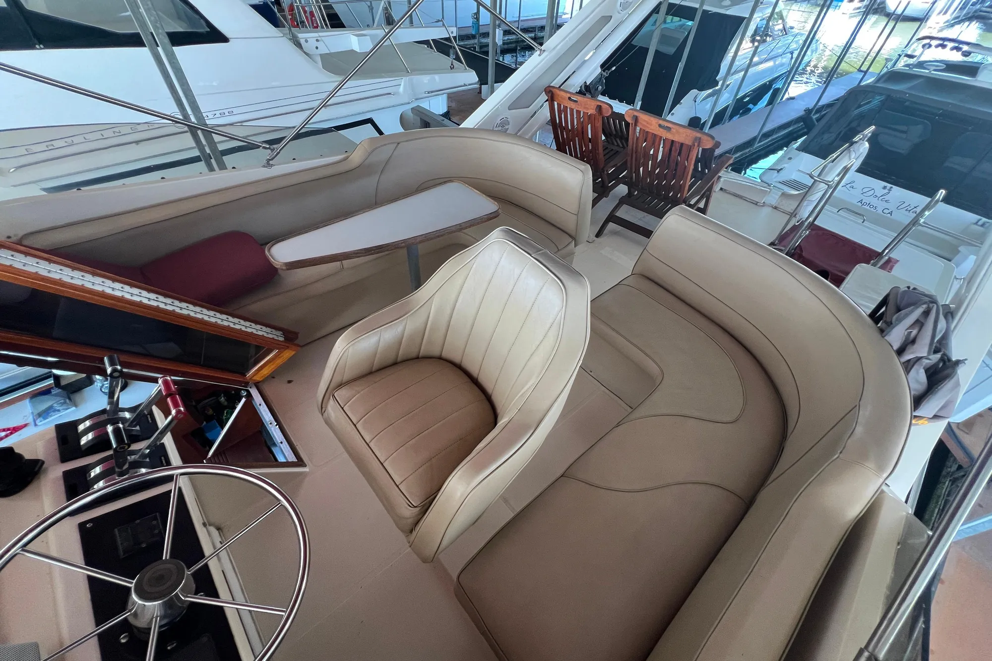1986 Bayliner 4550 Motoryacht interior with beige seating and steering wheel.