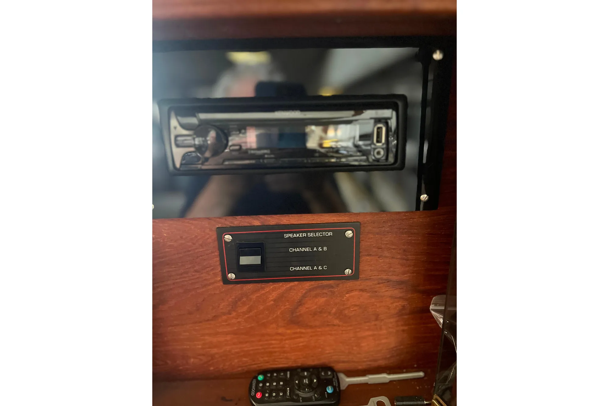 Control panel and speaker selector on 1986 Bayliner 4550 Motoryacht dashboard.