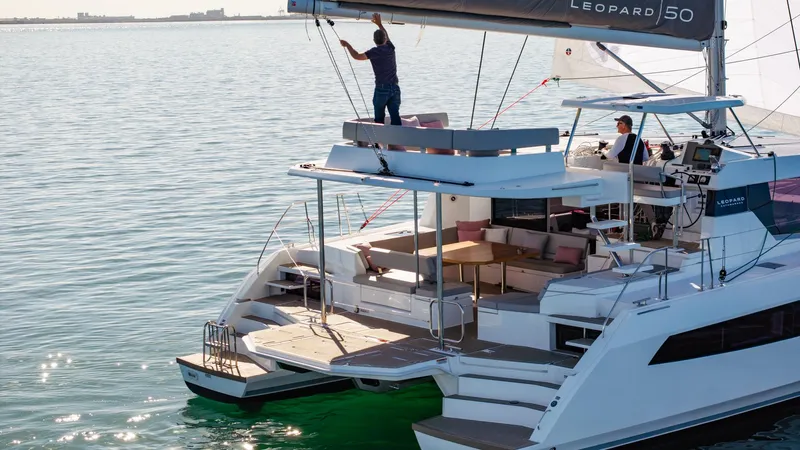  Yacht Photos Pics 2024 Leopard 50 catamaran sailing on calm waters, featuring spacious deck and modern design.