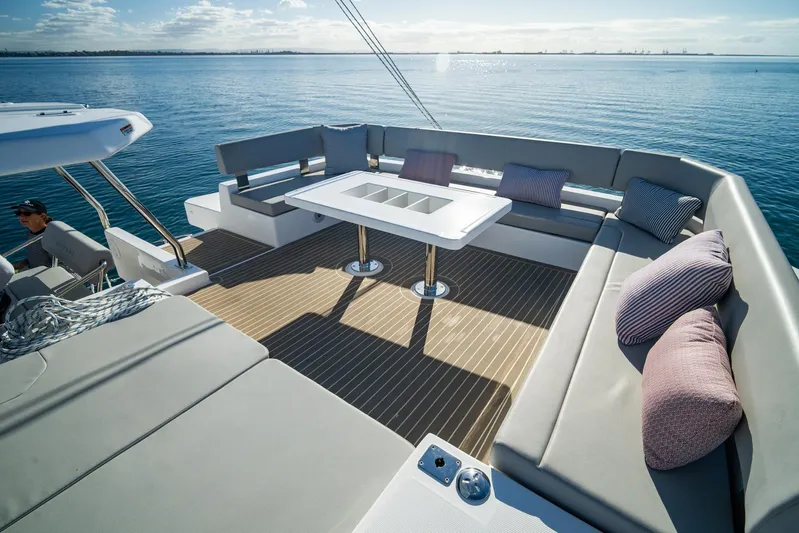  Yacht Photos Pics Luxurious 2024 Leopard 50 yacht deck with seating, table, and ocean view.