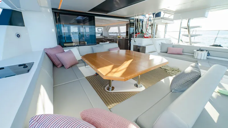  Yacht Photos Pics Luxurious 2024 Leopard 50 yacht interior with spacious seating and elegant wooden table.