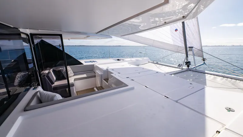  Yacht Photos Pics Luxurious 2024 Leopard 50 yacht deck with seating, overlooking serene ocean waters.