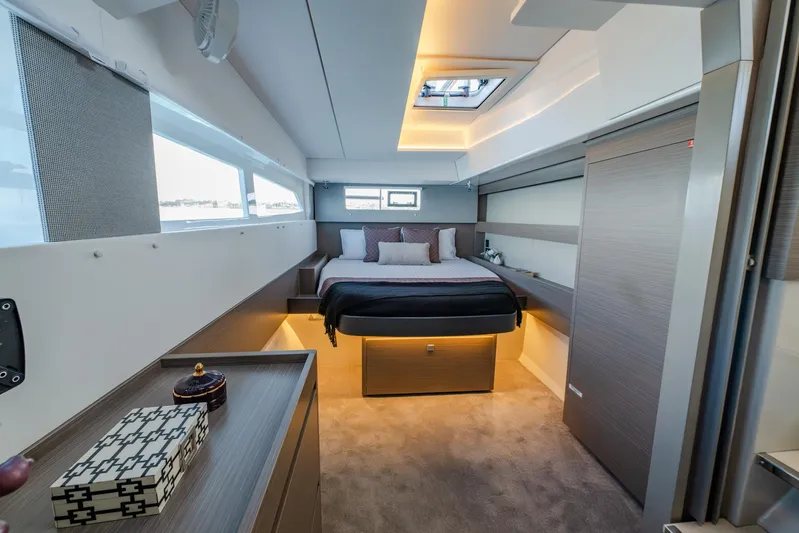 Yacht Photos Pics Luxurious bedroom interior of 2024 Leopard 50 yacht with modern design and ambient lighting.