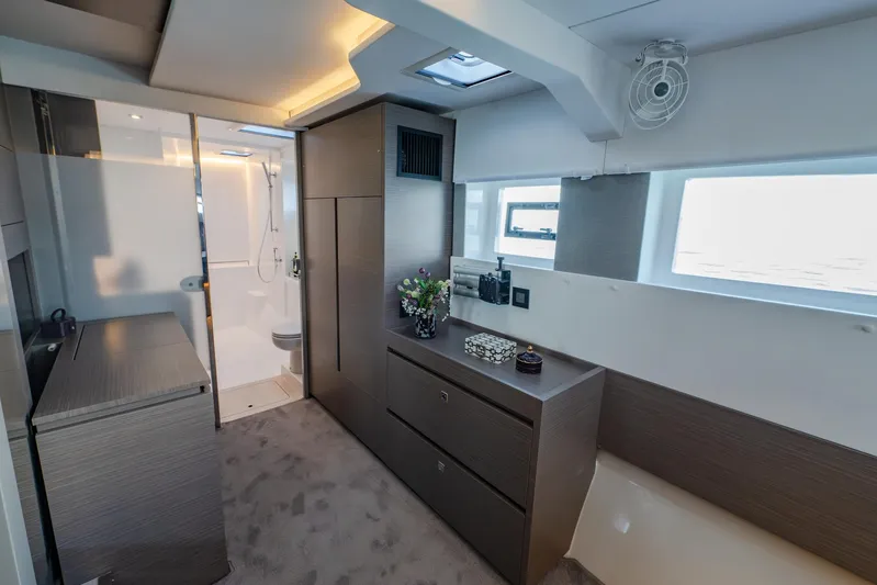  Yacht Photos Pics Luxurious interior of 2024 Leopard 50 yacht featuring modern cabinetry and ensuite bathroom.