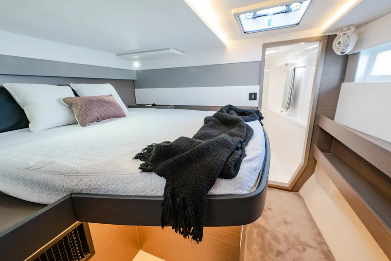  Yacht Photos Pics Luxurious bedroom interior of 2024 Leopard 50 yacht with modern design and cozy bedding.