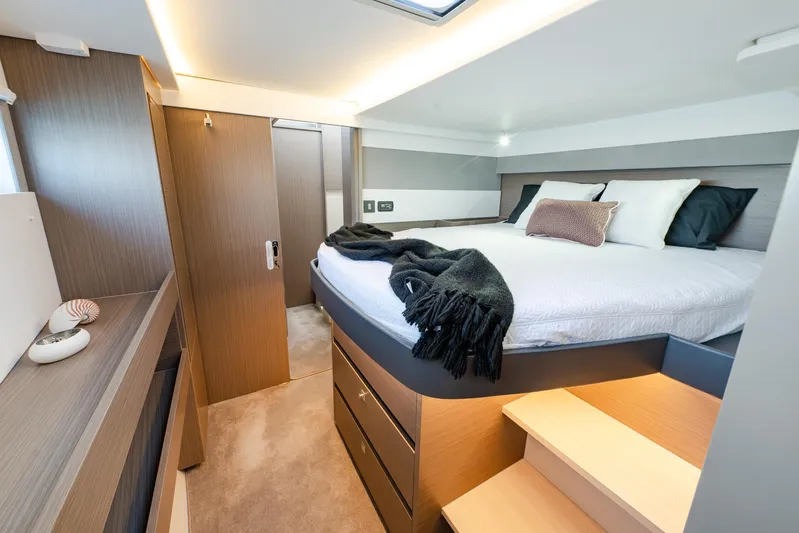  Yacht Photos Pics Luxurious bedroom interior of 2024 Leopard 50 yacht with modern design and cozy bedding.