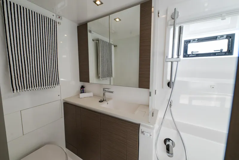  Yacht Photos Pics Modern bathroom interior on a 2024 Leopard 50 yacht, featuring sleek fixtures and striped towel.