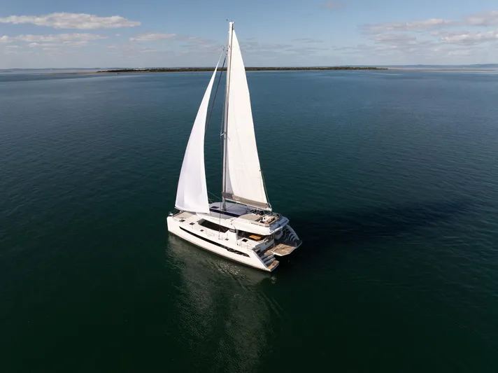  Yacht Photos Pics Sailing catamaran Leopard 50, 2024 model, cruising on open sea under clear skies.