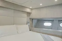 Luxurious bedroom interior of 2006 Arno Leopard 31 OPEN yacht with modern design.