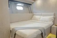 Luxurious bedroom interior of 2006 Arno Leopard 31 OPEN yacht with cozy bedding.