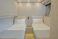 Twin beds in a modern cabin of a 2006 Arno Leopard 31 OPEN yacht.