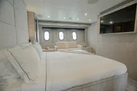 Luxurious bedroom interior of 2006 Arno Leopard 31 OPEN yacht with modern decor and large windows.