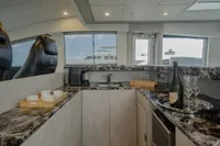 Luxurious interior of 2006 Arno Leopard 31 OPEN yacht with marble countertops and champagne.