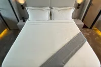 Luxurious bedroom interior on 2006 Arno Leopard 31 OPEN yacht, featuring elegant bedding and ambient lighting.