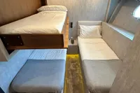 Cabin interior of 2006 Arno Leopard 31 OPEN yacht with three beds.